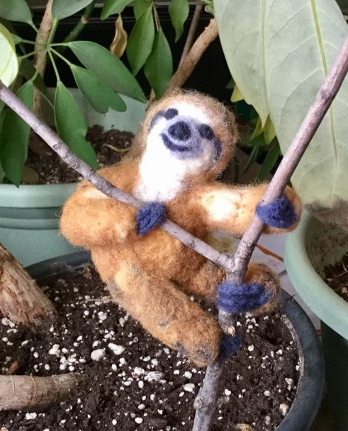 Sloth on a stick in potted plant